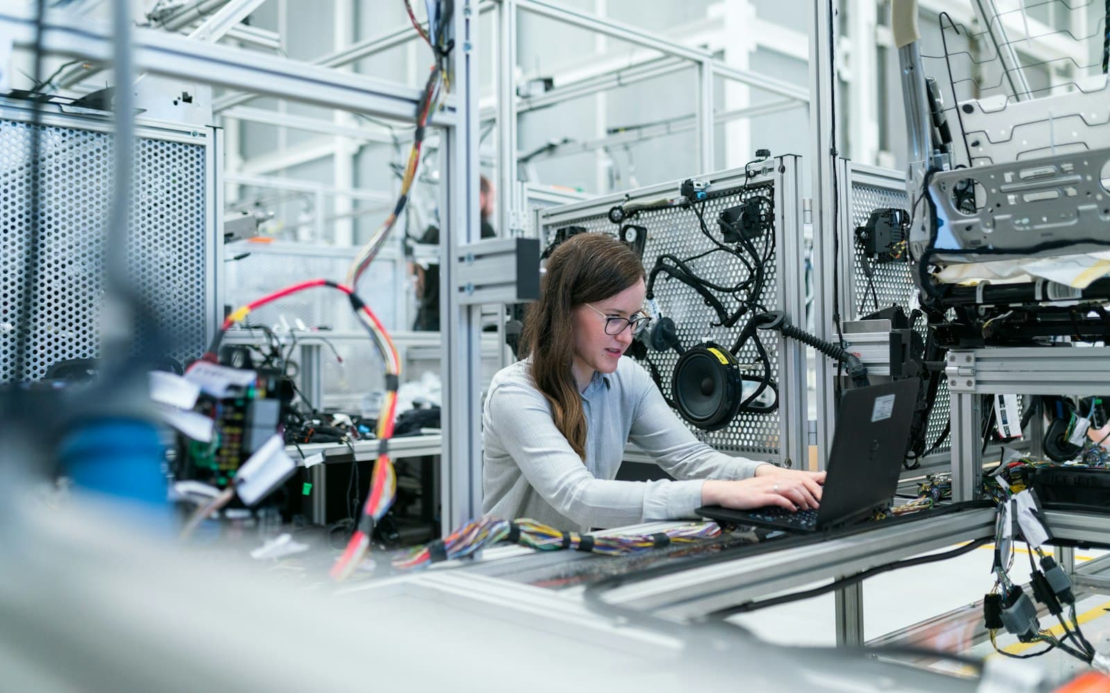 Vrouw werkt op een laptop in een technische werkplaats